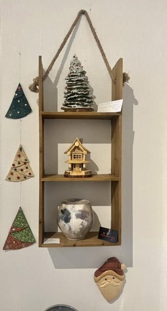 Seasonal display shelf with ceramic tree and pottery