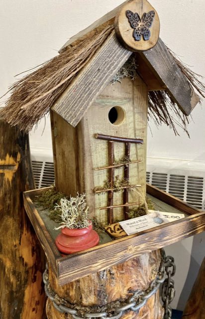 Rustic thatched-roof birdhouse